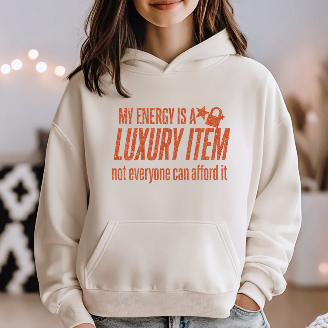 Person wearing a beige hoodie with a humorous text design.