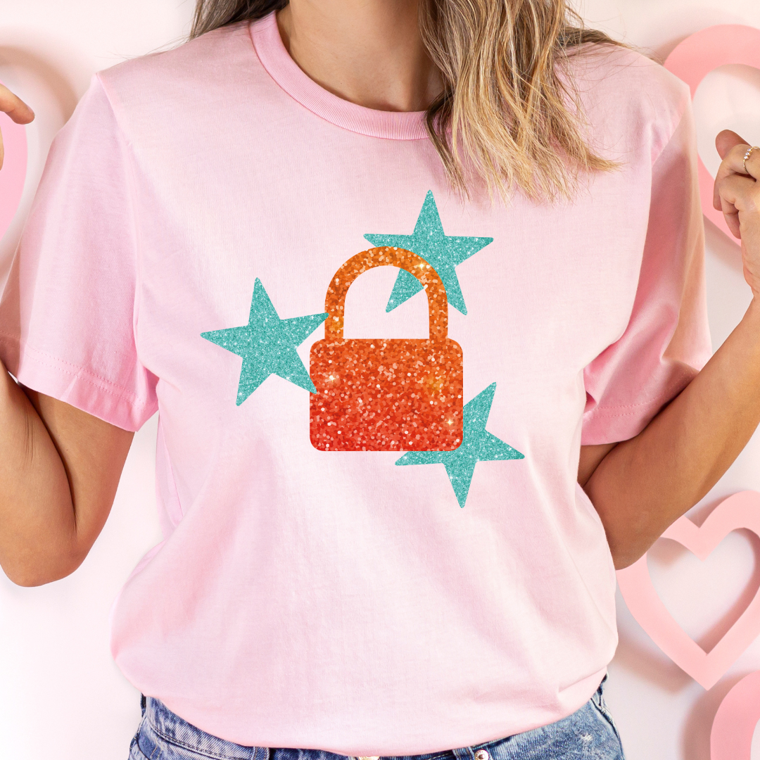 Person wearing a pink t-shirt with a colorful handbag and star design.