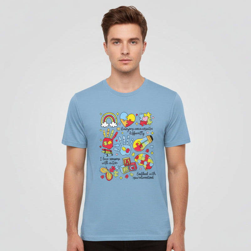 Light blue t-shirt with colorful autism awareness graphics and text on a white background