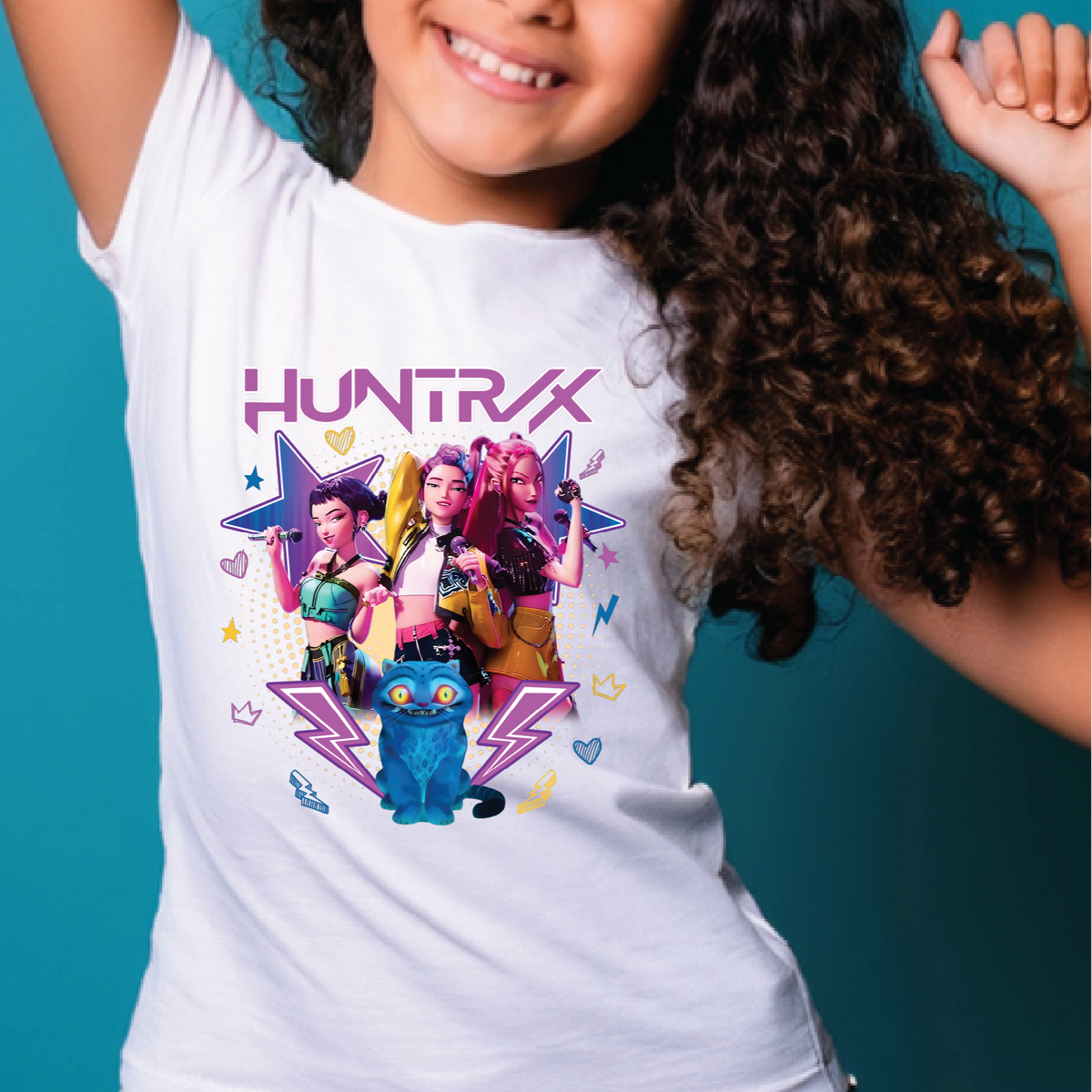 Child wearing a white t-shirt with 'HUNTRAX' design on a teal background