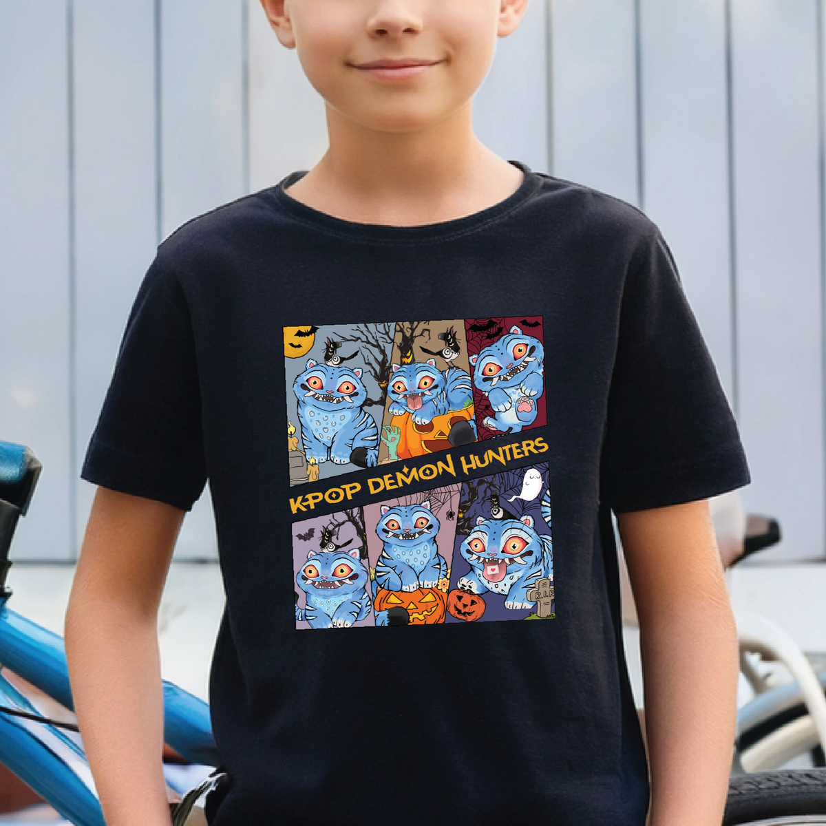 Child wearing a black t-shirt with a colorful graphic design of k-pop demon hunters, sitting outdoors.