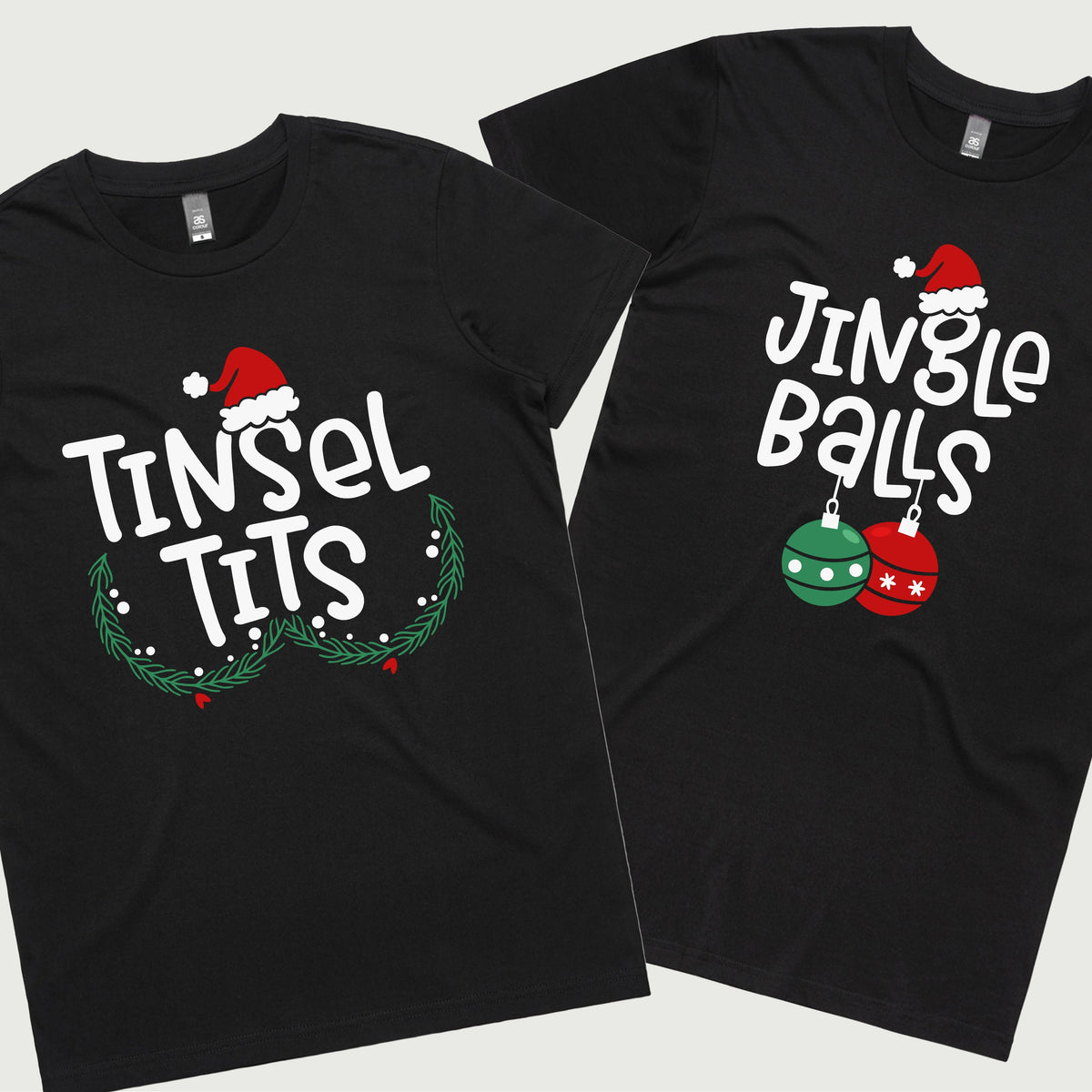 Two black t-shirts, one with the text 'TINSEL TITS' and Christmas-themed decorations, and the other with 'JINGLE BALLS' and a Christmas tree graphic. Both shirts have a festive, Christmas-themed design.
