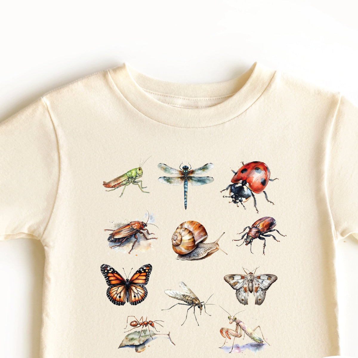 A beige t-shirt with a collection of colorful illustrated bugs and the text 'LOTS OF SELLES & COLOURS'.