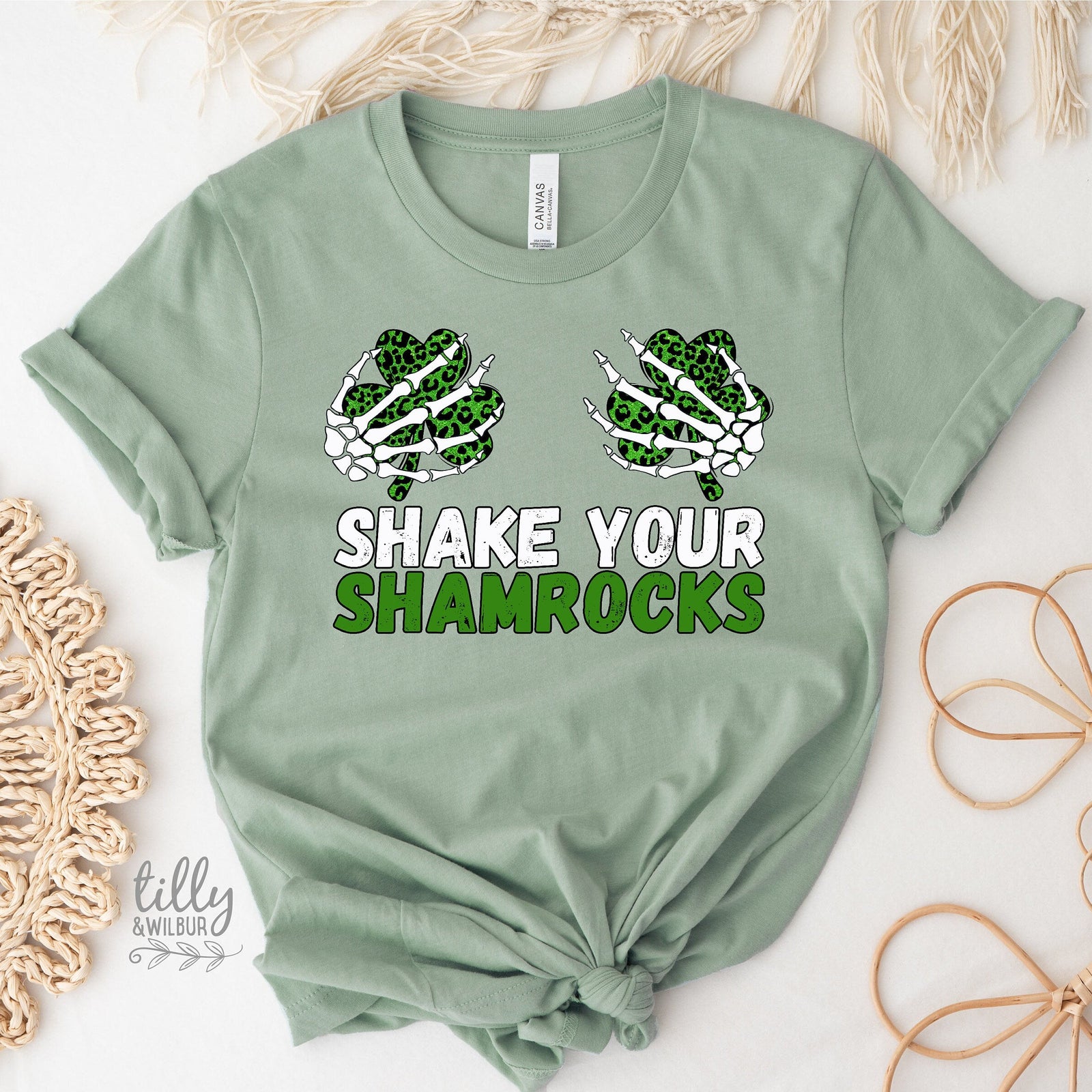 Green t-shirt with skeleton shamrock design and 'Shake Your Shamrocks' text on a white background.
