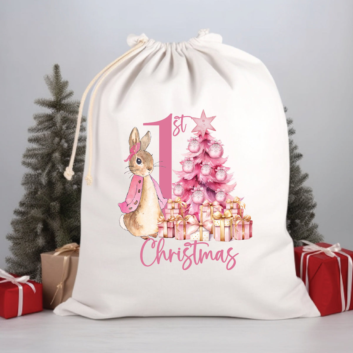 A white Christmas-themed drawstring sack featuring an illustration of a cartoon rabbit in Santa's outfit, with Christmas trees and gifts around it.