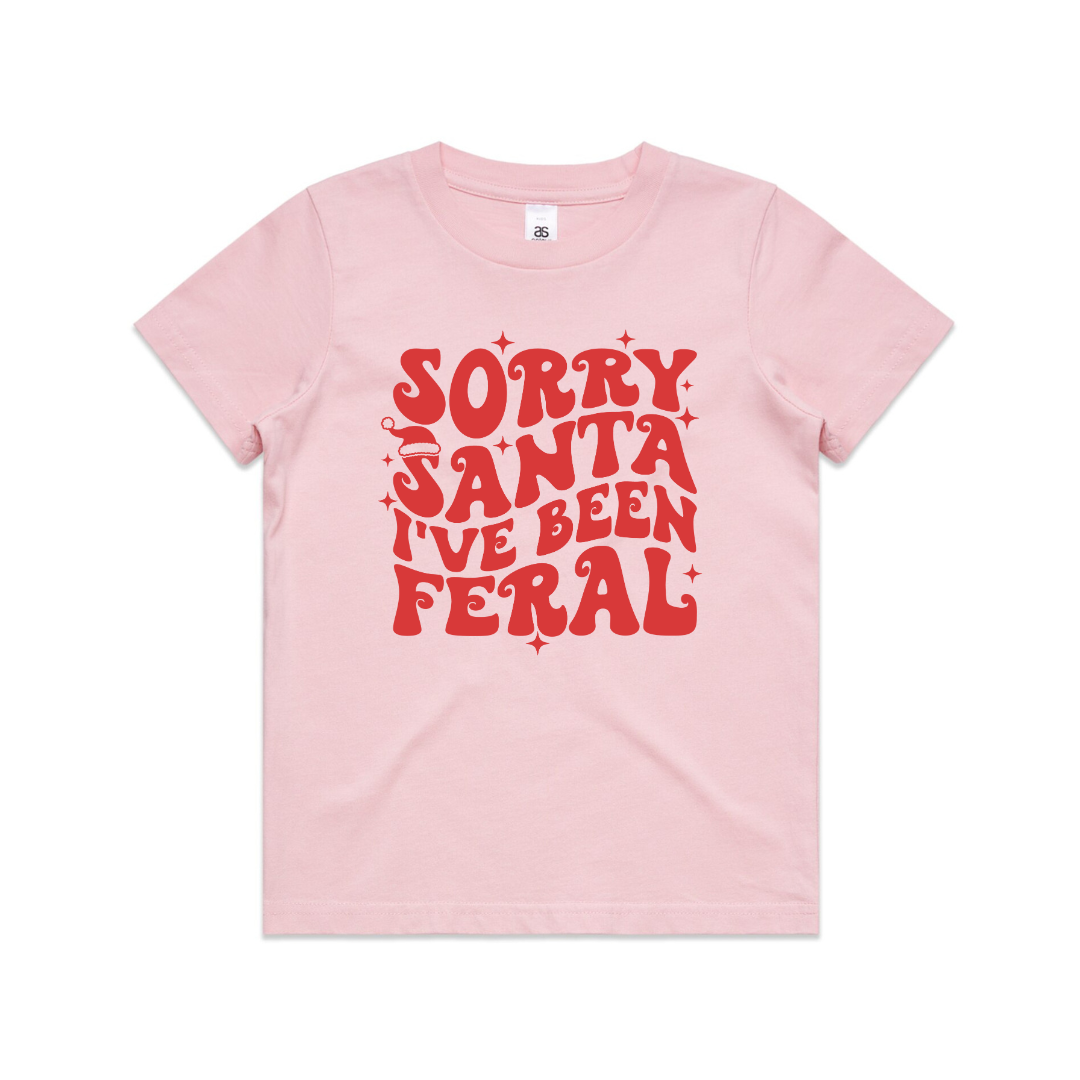 Beige t-shirt with red text 'Sorry Santa I've Been Feral' on a white background