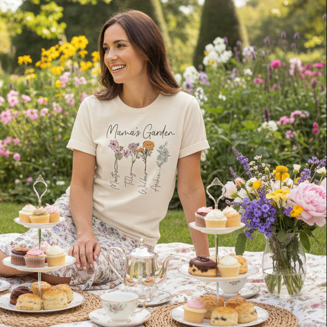 A beige-colored t-shirt with a personalized garden design, featuring text and a floral pattern. The design includes spaces for adding personal names.