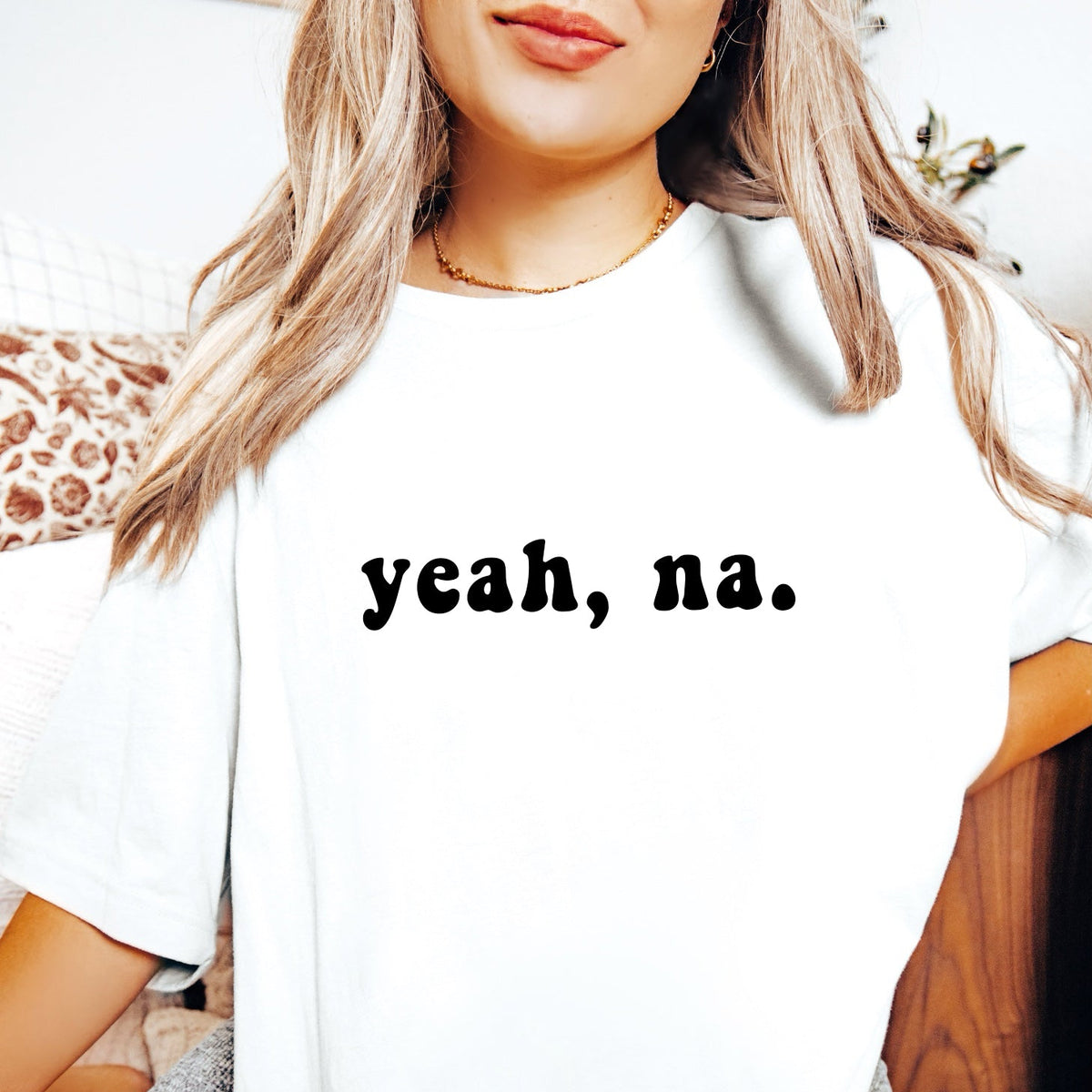 White t-shirt with 'yeah, na.' text on front and 'na, yeah.' text on back worn by a person.