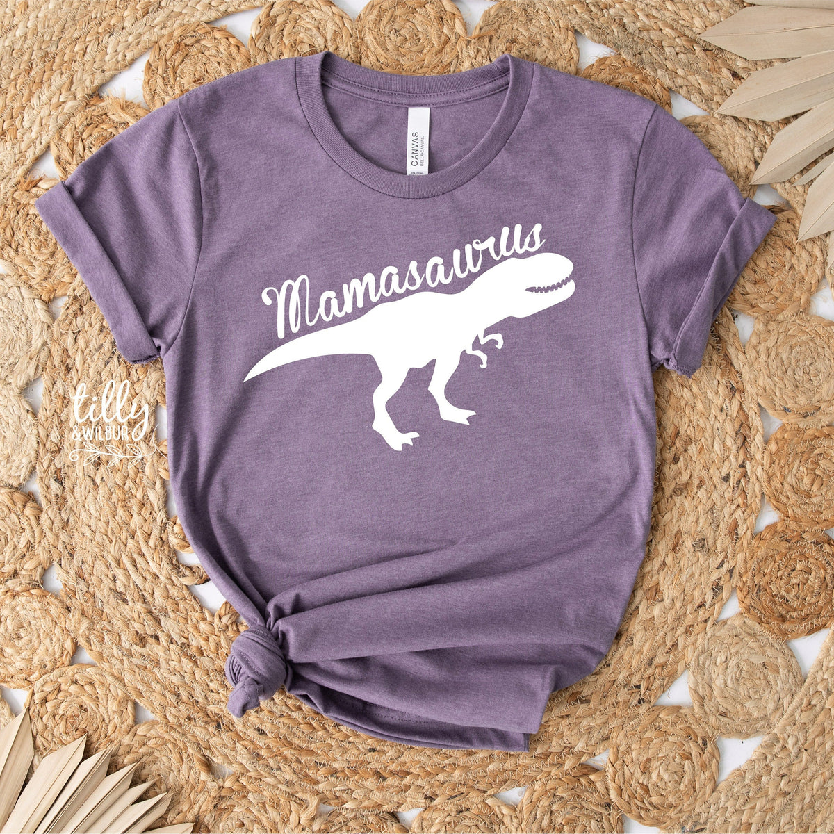 Purple t-shirt with 'Mamasaurus' design on a woven mat