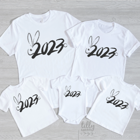 White t-shirts with the text '2023' and rabbit illustrations, indicating the Lunar New Year celebration.