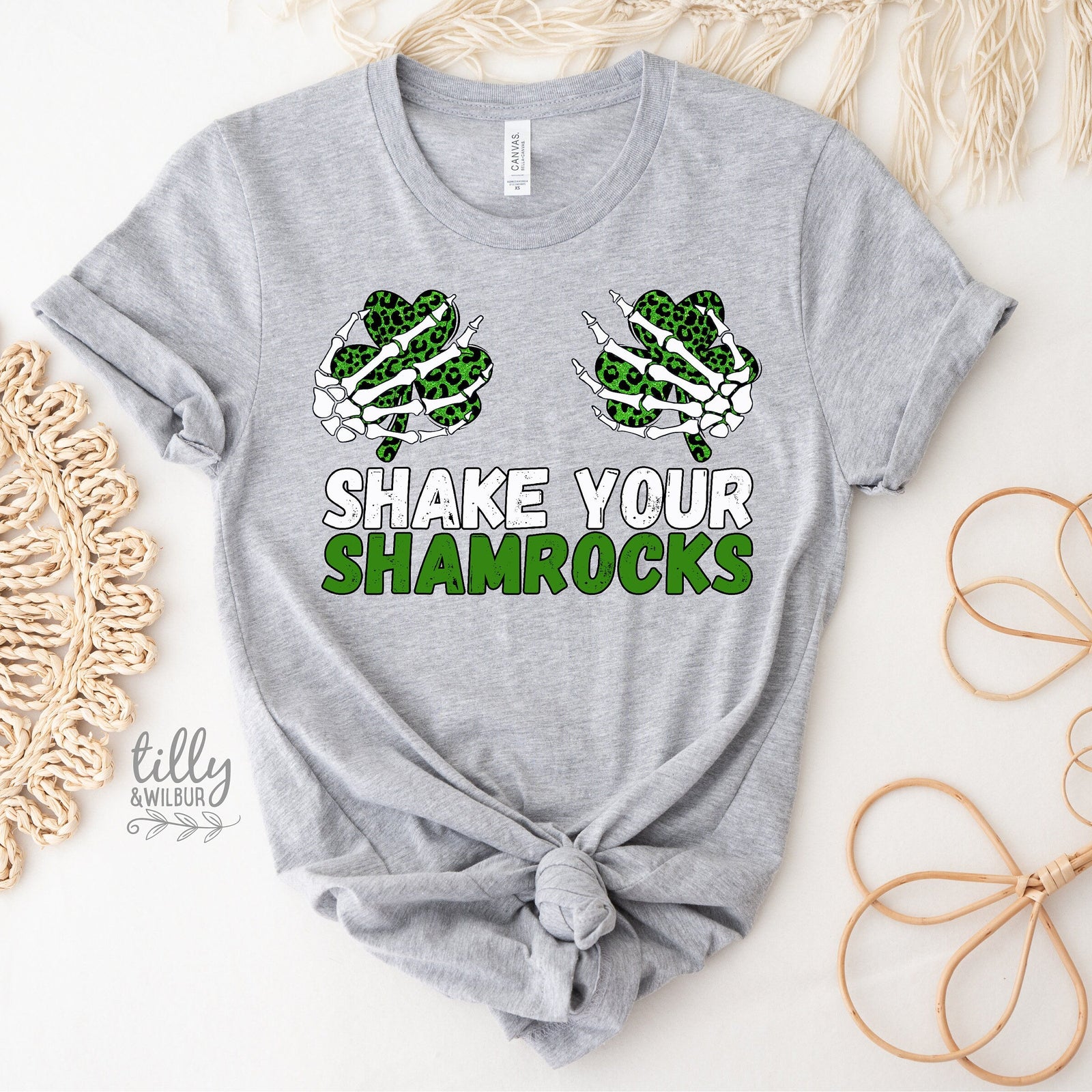 White t-shirt with shamrock design and text 'Shake Your Shamrocks' on a light background